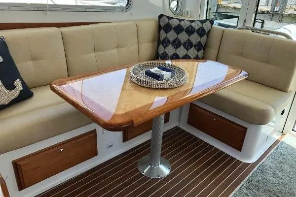  Yacht Photos Pics Luxurious interior of 2018 Back Cove Downeast 37 with elegant seating and polished wood table.