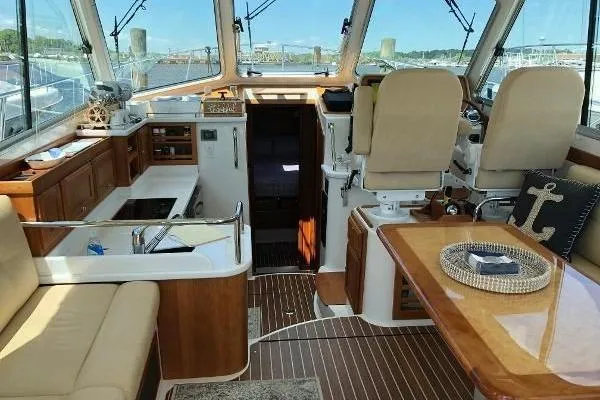  Yacht Photos Pics 2018 Back Cove Downeast 37 interior with helm, seating, and wooden finishes.