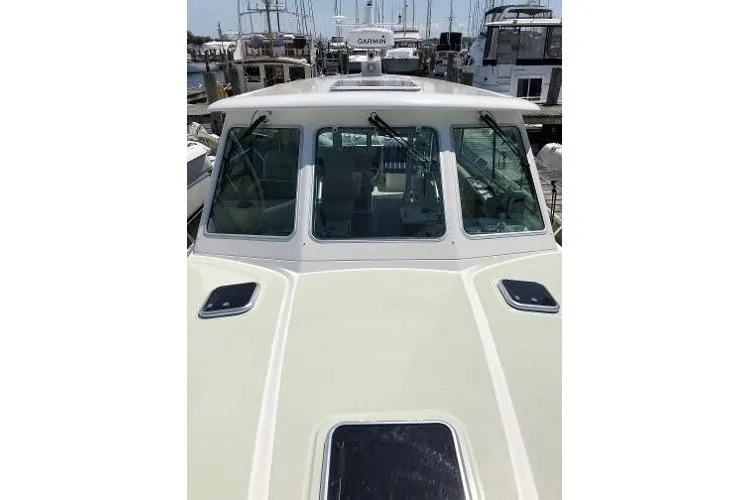  Yacht Photos Pics 2018 Back Cove Downeast 37 boat docked, showcasing front cabin and windows.