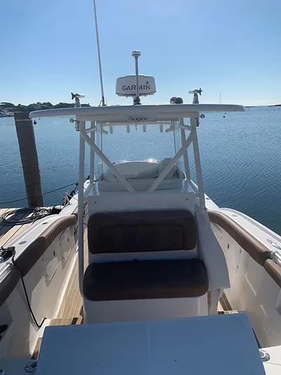  Yacht Photos Pics 2016 Buddy Davis 28 Center Console boat docked by calm waters.