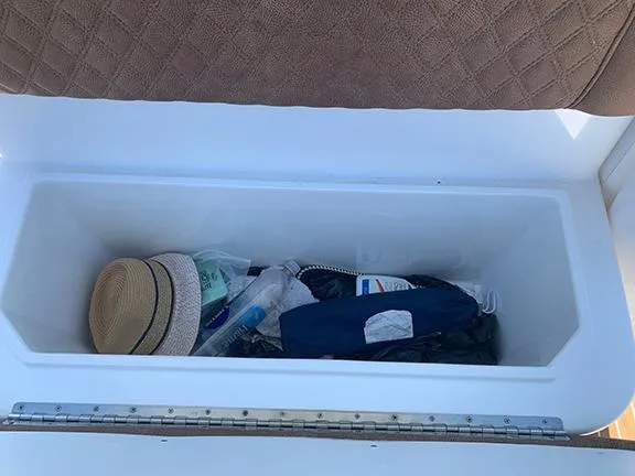  Yacht Photos Pics Open storage compartment on 2016 Buddy Davis 28 Center Console boat with various items inside.