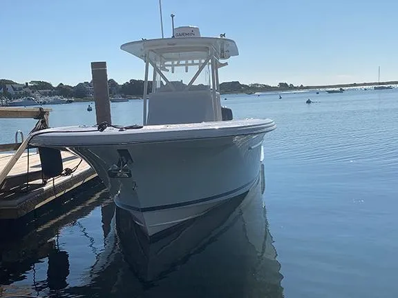  Yacht Photos Pics 2016 Buddy Davis 28 Center Console boat docked on calm water.
