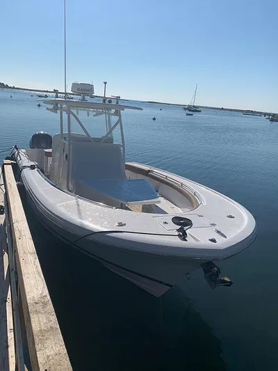  Yacht Photos Pics 2016 Buddy Davis 28 Center Console boat docked on calm water.