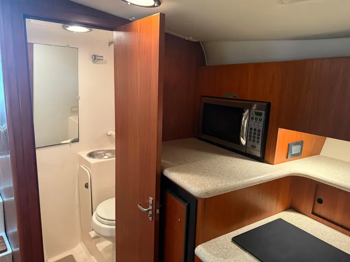 Awol Yacht Photos Pics 2003 Tiara Yachts 3100 Open LE interior with kitchenette and bathroom.