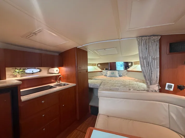 Awol Yacht Photos Pics Luxurious interior of 2003 Tiara Yachts 3100 Open LE with cozy bed and kitchenette.