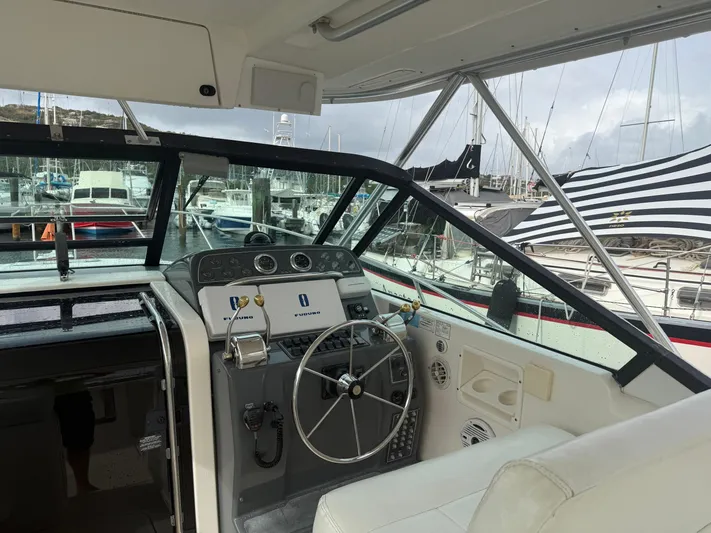 Awol Yacht Photos Pics 2003 Tiara Yachts 3100 Open LE helm with marina view, featuring navigation equipment.