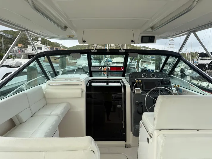 Awol Yacht Photos Pics 2003 Tiara Yachts 3100 Open LE cockpit with helm, white seating, and marina view.