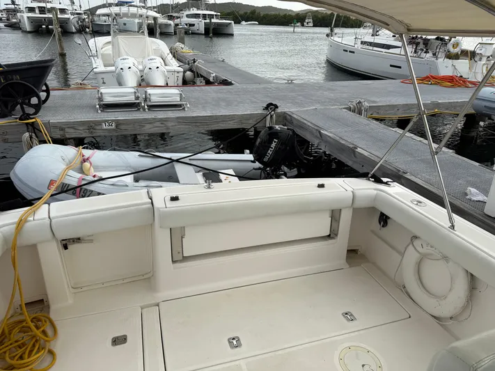 Awol Yacht Photos Pics 2003 Tiara Yachts 3100 Open LE at marina, featuring spacious deck and nearby boats.