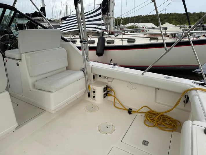 Awol Yacht Photos Pics 2003 Tiara Yachts 3100 Open LE interior with seating and docked boats in background.