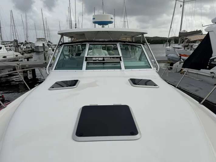 Awol Yacht Photos Pics 2003 Tiara Yachts 3100 Open LE docked at marina under cloudy skies.