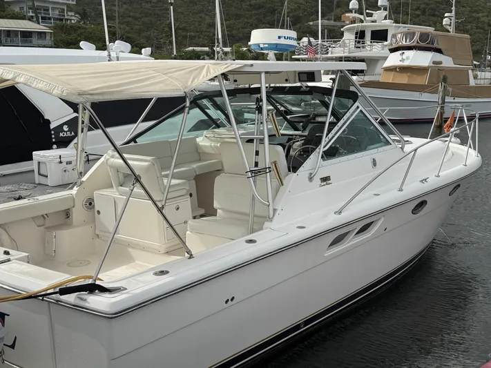 Awol Yacht Photos Pics 2003 Tiara Yachts 3100 Open LE docked, featuring sleek design and spacious seating.