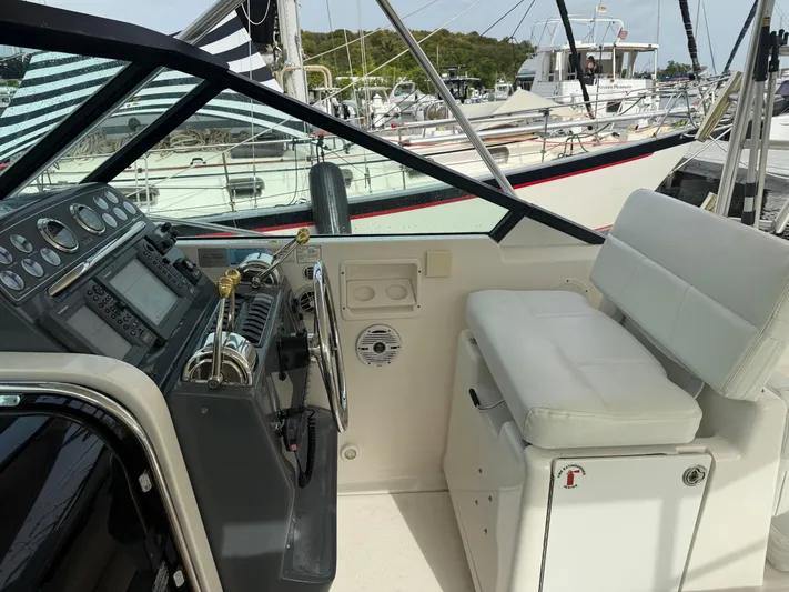 Awol Yacht Photos Pics 2003 Tiara Yachts 3100 Open LE helm with controls and seating, docked at marina.
