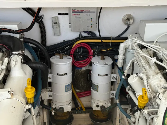 Awol Yacht Photos Pics Engine compartment of a 2003 Tiara Yachts 3100 Open LE, showcasing fuel filters and wiring.