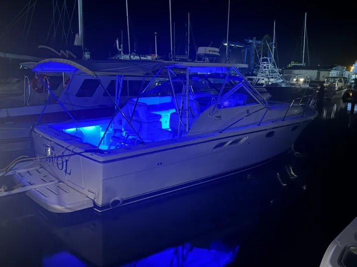Awol Yacht Photos Pics 2003 Tiara Yachts 3100 Open LE with blue LED lights at night dock.