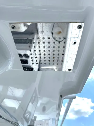  Yacht Photos Pics 2022 Sea Pro 320 DLX Center Console boat detail with metal fixture and sky reflection.