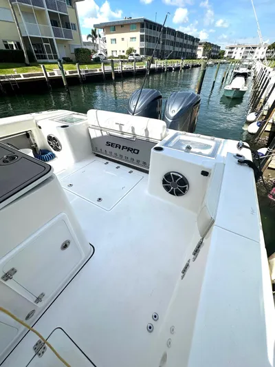  Yacht Photos Pics 2022 Sea Pro 320 DLX Center Console boat docked in a marina, showcasing spacious deck.