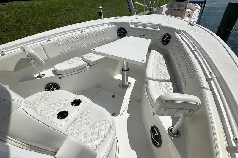  Yacht Photos Pics 2022 Sea Pro 320 DLX Center Console boat with luxurious white seating and table.