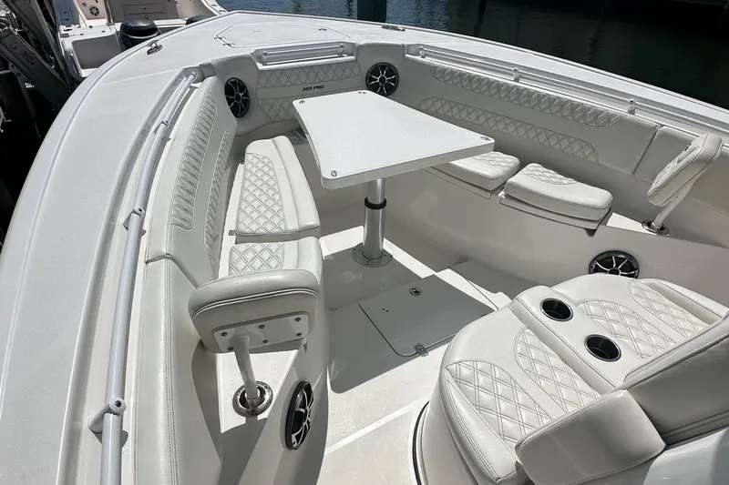  Yacht Photos Pics 2022 Sea Pro 320 DLX Center Console boat interior with white seating and table.
