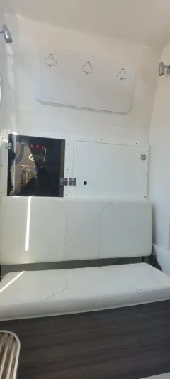  Yacht Photos Pics 2022 Sea Pro 320 DLX Center Console interior with white seating and storage compartments.