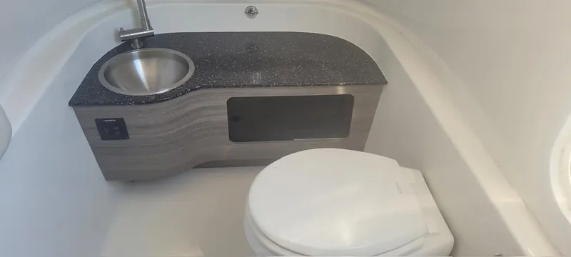  Yacht Photos Pics 2022 Sea Pro 320 DLX Center Console bathroom with sink and toilet.