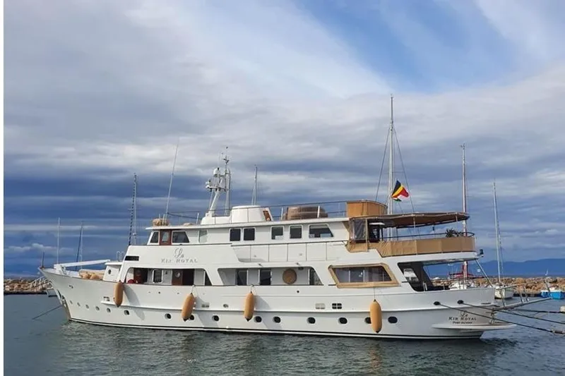 Le Kir Royal Yacht Photos Pics 1966 Full Displacement Motor Yacht in harbor, under cloudy sky, side view.
