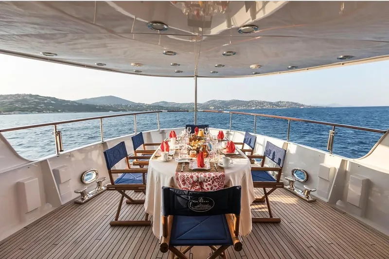 Le Kir Royal Yacht Photos Pics Luxurious dining setup on a 1966 Full Displacement Motor Yacht, overlooking serene ocean views.