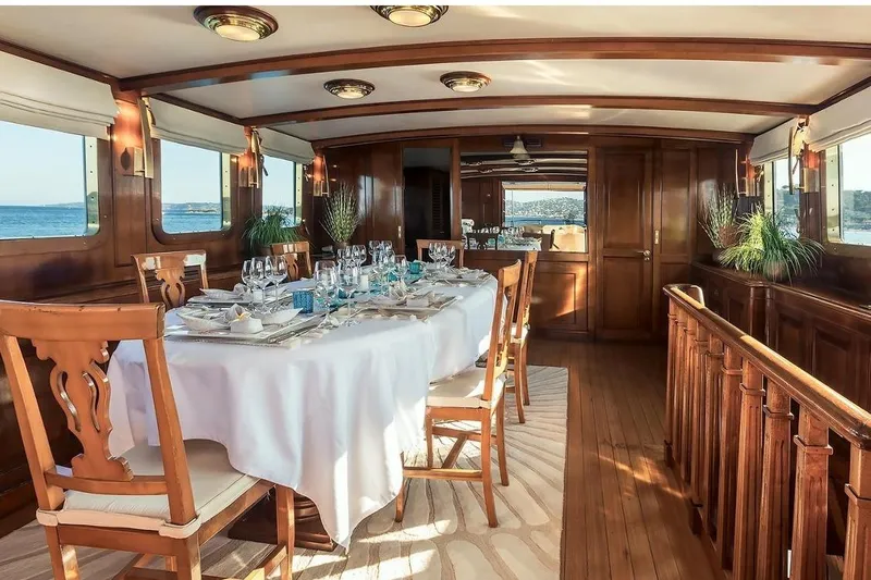 Le Kir Royal Yacht Photos Pics Luxurious dining area on a 1966 Full Displacement Motor Yacht with elegant wooden interiors.