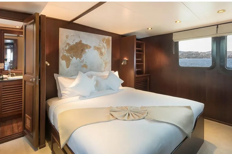 Le Kir Royal Yacht Photos Pics Luxurious 1966 Full Displacement Motor Yacht bedroom with ocean view and elegant decor.
