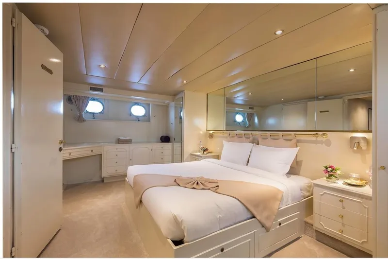 Le Kir Royal Yacht Photos Pics Luxurious bedroom interior on a 1966 Full Displacement Motor Yacht, featuring elegant decor and cozy ambiance.