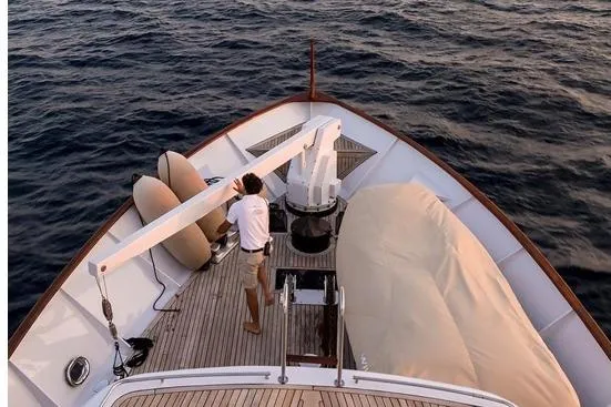 Le Kir Royal Yacht Photos Pics 1966 Full Displacement Motor Yacht deck with person adjusting equipment, ocean background.