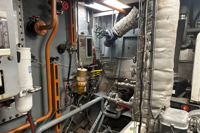 Le Kir Royal Yacht Photos Pics Engine room of a 1966 Full Displacement Motor Yacht, showcasing pipes and machinery.