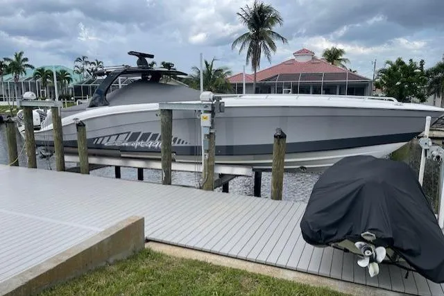 Roweboat Yacht Photos Pics 2010 Concept 4400 Sport Yacht docked near palm trees and waterfront homes.