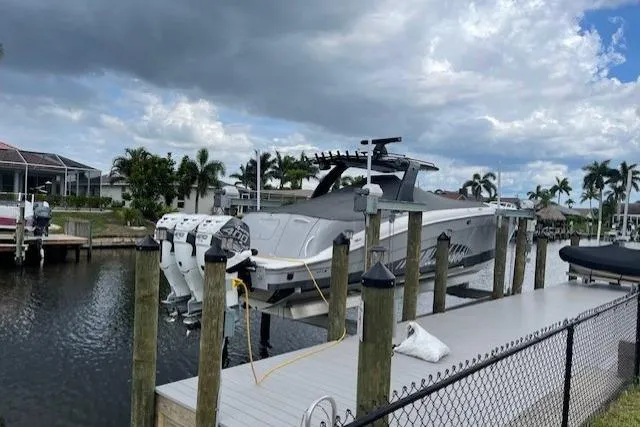 Roweboat Yacht Photos Pics 2010 Concept 4400 Sport Yacht docked, featuring multiple outboard engines, under a cloudy sky.