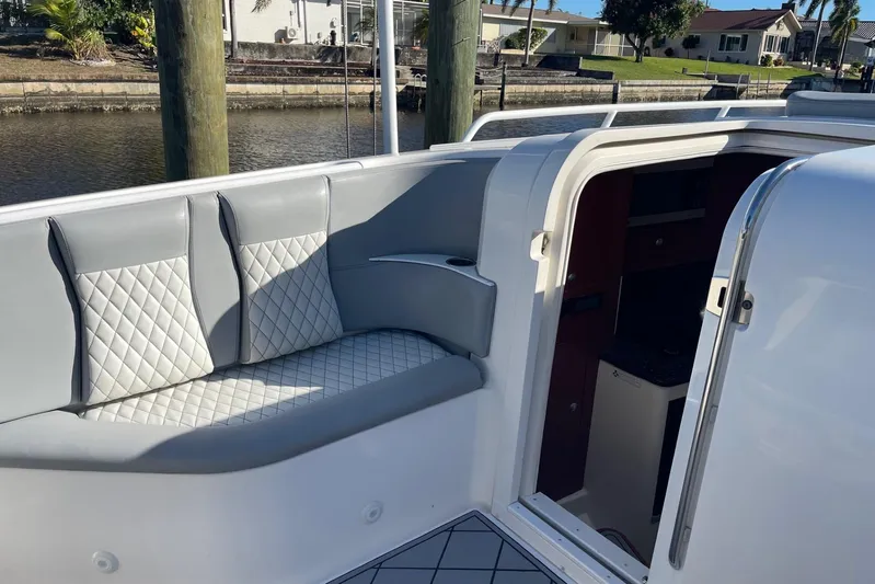 Roweboat Yacht Photos Pics 2010 Concept 4400 Sport Yacht interior with gray quilted seating by the water.