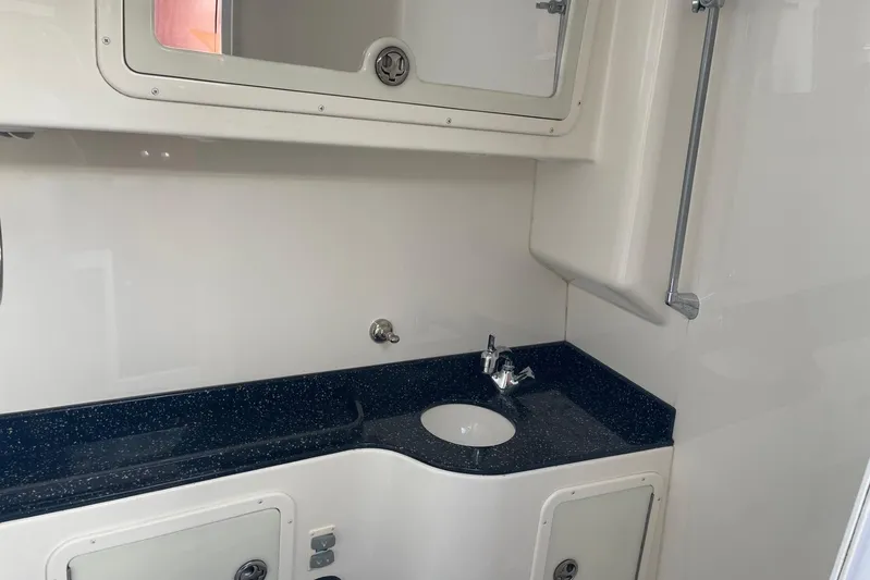 Roweboat Yacht Photos Pics 2010 Concept 4400 Sport Yacht bathroom with sleek black countertop and modern fixtures.