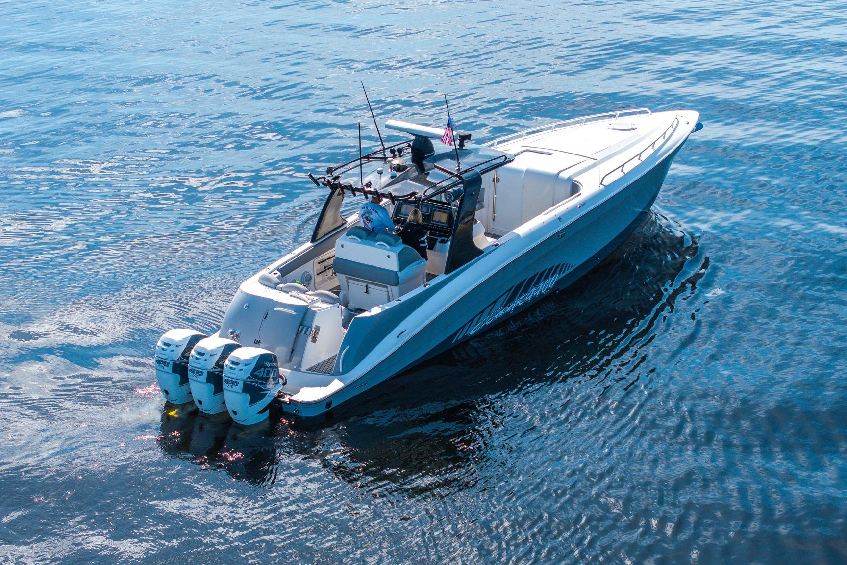 2010 Concept 4400 Sport Yacht cruising on open water, featuring triple outboard engines.
