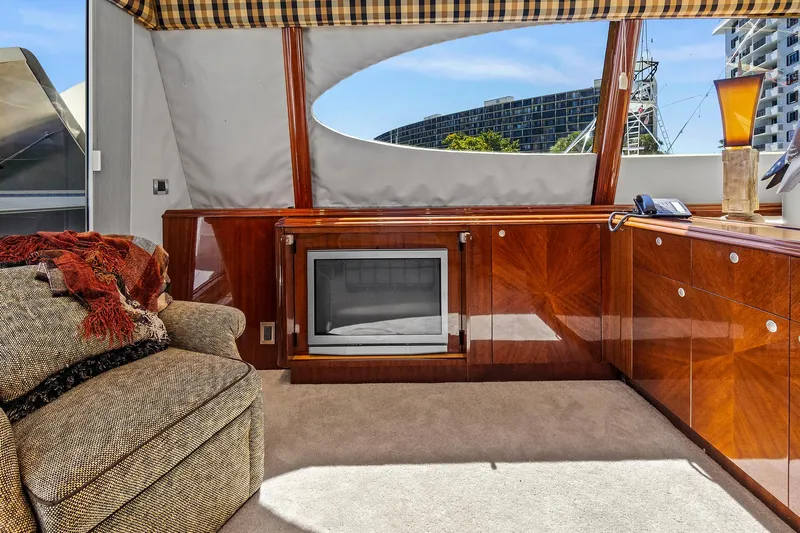 Touch The Sun Yacht Photos Pics Luxurious interior of 2004 Lazzara 80 SL yacht with elegant wood cabinetry and cozy seating.