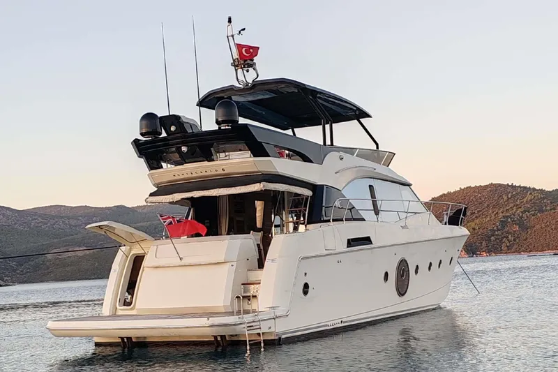  Yacht Photos Pics 2015 Beneteau Monte Carlo 6 yacht on serene water with scenic backdrop.