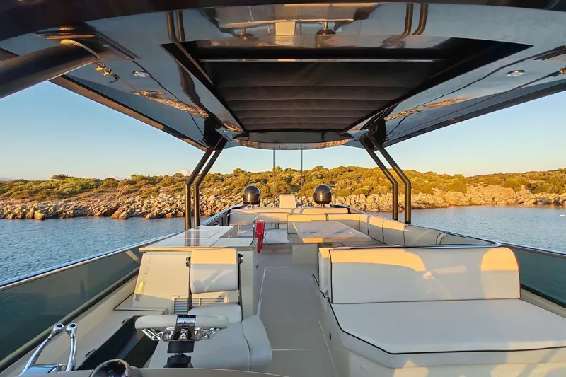  Yacht Photos Pics Luxurious 2015 Beneteau Monte Carlo 6 yacht deck with elegant seating and scenic coastal view.