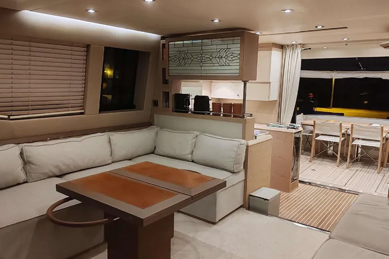  Yacht Photos Pics Luxurious interior of 2015 Beneteau Monte Carlo 6 yacht with elegant seating and dining area.