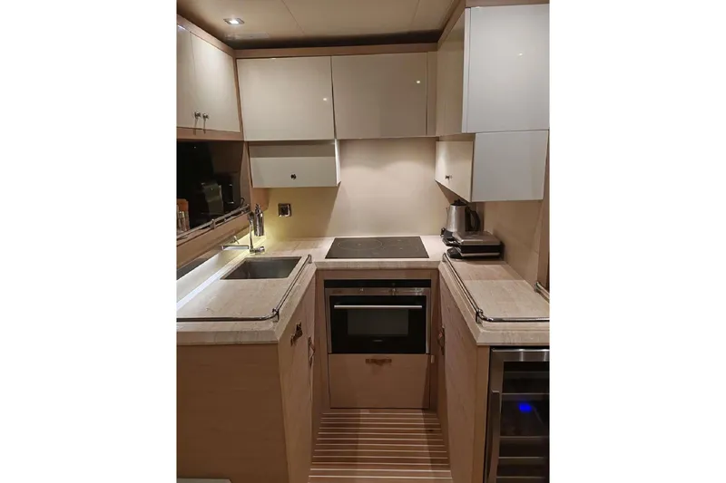  Yacht Photos Pics Modern kitchen interior on 2015 Beneteau Monte Carlo 6 yacht, featuring sleek cabinetry and appliances.