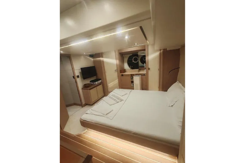 Yacht Photos Pics Luxurious bedroom interior of 2015 Beneteau Monte Carlo 6 yacht, featuring modern amenities and elegant design.