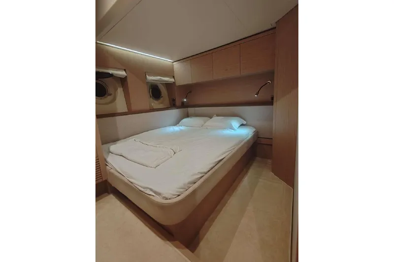  Yacht Photos Pics Luxurious cabin interior of 2015 Beneteau Monte Carlo 6 yacht, featuring a cozy bed.