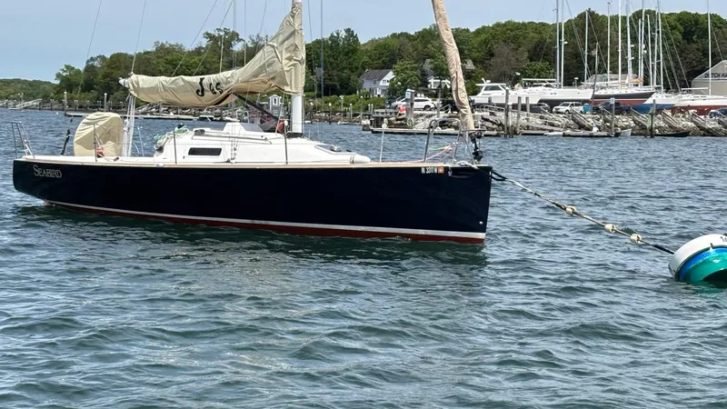 Seabird Yacht Photos Pics 2012 J Boats J/95 sailboat moored in a scenic marina setting.