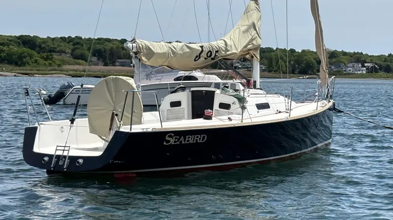 Seabird Yacht Photos Pics 2012 J Boats J/95 sailboat named "Seabird" anchored in calm waters.