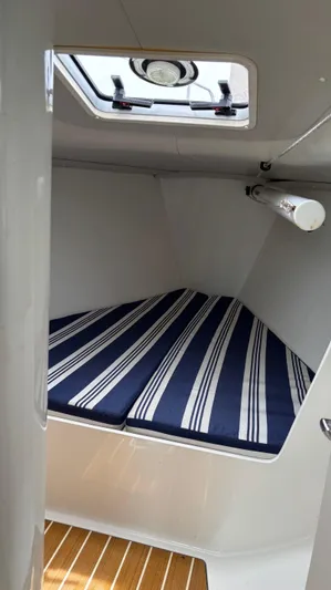 Seabird Yacht Photos Pics Cabin interior of 2012 J Boats J/95 with striped cushions and overhead hatch.