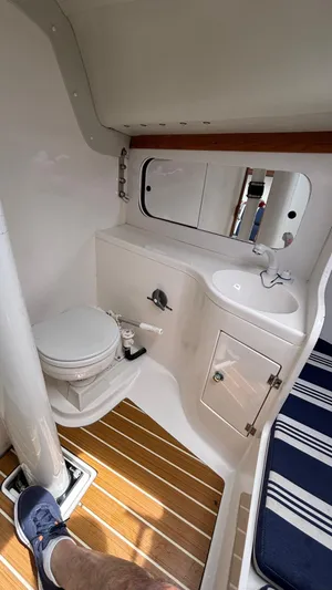 Seabird Yacht Photos Pics Interior of 2012 J Boats J/95 sailboat, featuring compact bathroom with toilet and sink.
