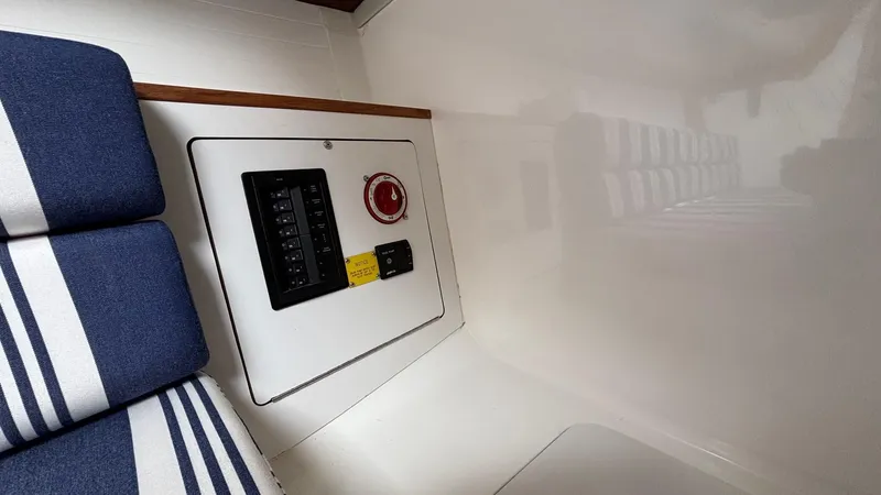 Seabird Yacht Photos Pics 2012 J Boats J/95 interior with control panel and striped seating.