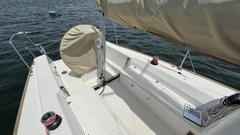 Seabird Yacht Photos Pics 2012 J Boats J/95 sailboat cockpit with covered wheel, winches, and seating on calm water.