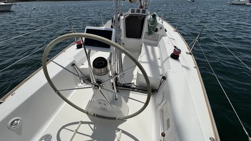 Seabird Yacht Photos Pics 2012 J Boats J/95 sailboat cockpit with steering wheel on calm water.
